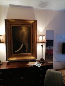 a picture of an elephant on a desk with a lamp at Harmony downtown apartment in Šabac