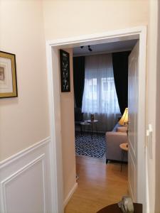 a door leading into a living room with a couch at Harmony downtown apartment in Šabac