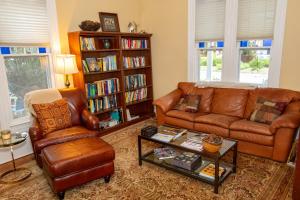 a living room with a leather couch and a coffee table at The Inn at Onancock in Onancock