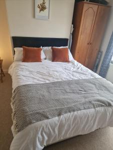 a large white bed with two pillows on it at Majestic! Beautiful home in a posh neighbourhood in Liverpool