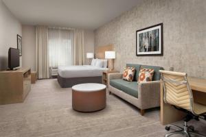 um quarto de hotel com uma cama e um sofá em DoubleTree by Hilton North Salem em Salem