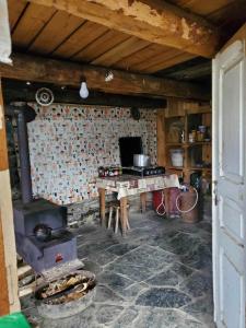 a kitchen with a stove and a table in a room at paradise of tusheti in Omalo