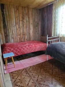 a bedroom with a bed in a wooden cabin at paradise of tusheti in Omalo