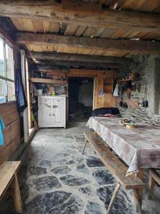a room with a bed and a table in a house at paradise of tusheti in Omalo