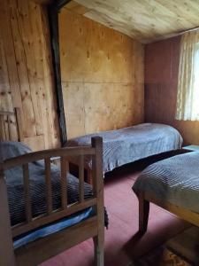 a bedroom with two beds in a cabin at paradise of tusheti in Omalo