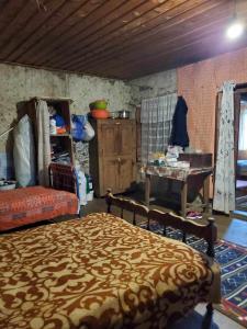 a bedroom with a bed and a table in a room at paradise of tusheti in Omalo