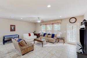 a living room with couches and a tv at Hidden Springs Oasis in San Antonio