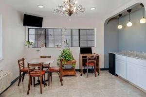 a kitchen and dining room with a table and chairs at Americas Best Value Inn San Antonio Downtown Riverwalk in San Antonio