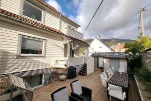 a deck with chairs and a table on a house at Superb and central place! Airb&b favorite in Bergen