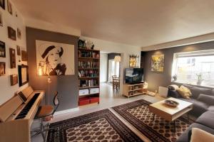 a living room with a couch and a piano at Superb and central place! Airb&b favorite in Bergen