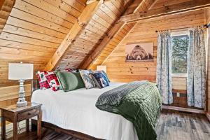 a bedroom with a bed in a log cabin at The Willows in Sevierville