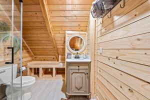a wooden bathroom with a toilet and a mirror at The Willows in Sevierville +44 photos