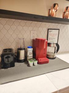 a kitchen counter with a red blender and other appliances at Starlight Guesthouse in West Orange