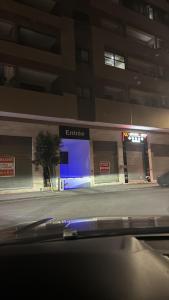 a store on the side of a street at night at Cosy Apartment Menara Garden in Marrakech