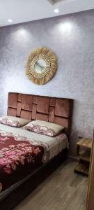a bedroom with a bed with a mirror on the wall at Cosy Apartment Menara Garden in Marrakech