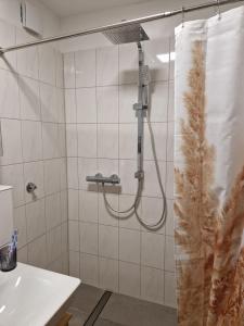um chuveiro na casa de banho com uma cortina de chuveiro em ruhige Privatzimmer im Apartment Natur Messe Zentral em Düsseldorf