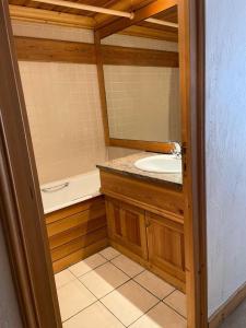 a bathroom with a sink and a mirror at Résidence Praz De La Legettaz - 4 Pièces pour 6 Personnes 574 in Val-d'Isère