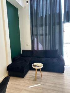 a living room with a blue couch and a table at Rent Room 2 Rolandi Apartments in Pogradec