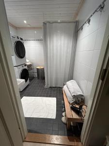 a bathroom with a shower and a bed in it at Trekker's Haven: Noux National Park Retreat in Espoo