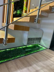 a modern house with stairs and green grass at Rent Room 2 Rolandi Apartments in Pogradec