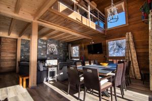 a dining room and kitchen with a table and chairs at Chalet KopÉrek - Chalets pour 12 Personnes 514 in Valloire