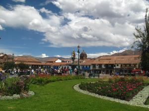 a group of people walking around a park with flowers at Casa De Mama Cusco - The Treehouse in Cusco