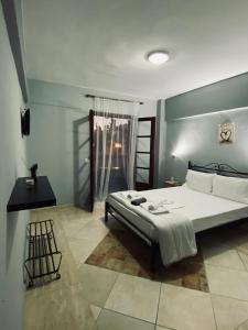 a bedroom with a large bed in a room at Alexandros apartments in Afitos