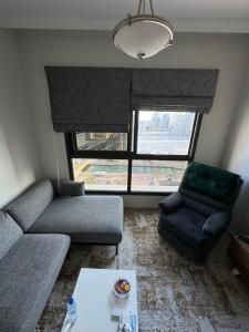 a living room with a couch and a chair at sharja 1103 in Sharjah