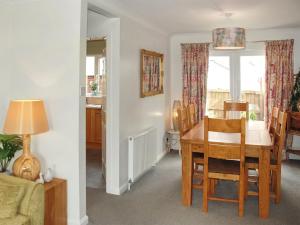 a dining room and living room with a table and chairs at Pilots Rest in Acklington