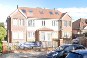 a house with a car parked in front of it at London Southgate 2bed Apartment in London