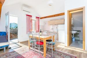 a kitchen and dining room with a table and chairs at Apartments by the sea Podaca, Makarska - 2783 in Podaca