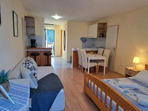 a living room with a bed and a dining room at Apartments by the sea Lumbarda, Korcula - 4385 in Lumbarda