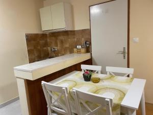 a kitchen with a table with four chairs and a counter at Apartments by the sea Lumbarda, Korcula - 4385 in Lumbarda +42 photos