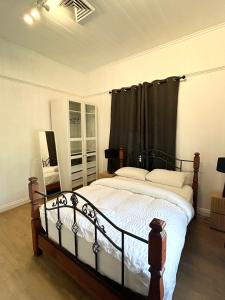 a bedroom with a bed with a black curtain at 26 Gladstone Rd Highgate Hill in Brisbane
