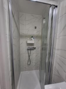 een badkamer met een douche en een wastafel bij Fuzzys place in Londen