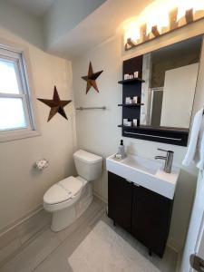 a bathroom with a toilet and a sink and stars on the wall at The Terrace Room @ Galleria in Houston