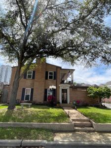 a house with a tree in front of it at The Terrace Room @ Galleria in Houston