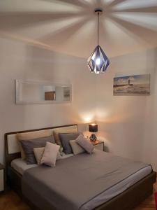 a bedroom with a bed and a pendant light at Family-friendly apartments with swimming pool Selca, Brac - 22810 in Selca +13 photos