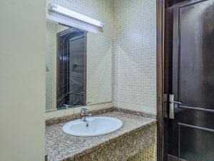 a bathroom with a sink and a mirror at Comfort Bed Inn in Dubai