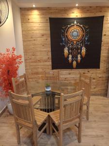 a dining room with a glass table and chairs at Louran Residence Hotel Apartments in Alexandria