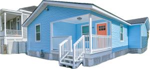 a blue house with an orange door and a balcony at Bella's Beach House 2811 Avenue O 1/2 in Galveston