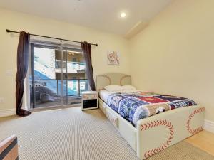 a bedroom with a bed and a large window at Freestyle in Brian Head