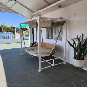 a porch swing with a hammock on a patio at HOTEL CASA BLANCA COEXIST SPACE in Oaxaca City