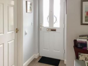 a white door in a room with a window at Bramley Lodge Annex in Clenchwarton