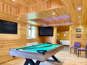 a pool table in a room with wooden walls at Magnolia Lodge-uk46280 in Camerton
