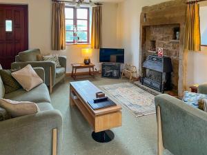 a living room with two couches and a fireplace at Holly Bank in Crich