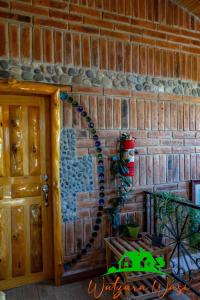 a brick wall with a christmas decoration on it at Watzara Wasi Cottage Familiar Camprestre Y Lofts en Cotacachi in Cotacachi