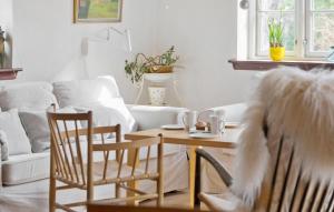a living room with a table and chairs at Awesome Home In Gilleleje With Kitchen in Gilleleje