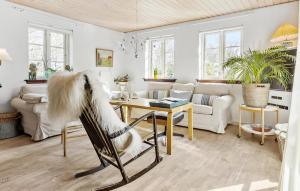 a woman is getting her hair done in a living room at Awesome Home In Gilleleje With Kitchen in Gilleleje