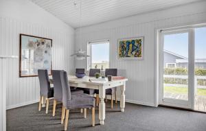a dining room with a white table and chairs at Gorgeous Home In Bogense With Kitchen in Bogense